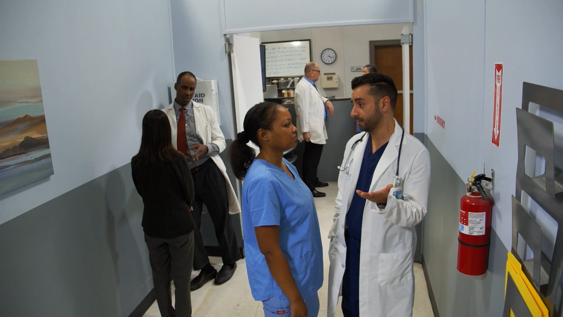 Healthcare professionals conferring in a hospital corridor